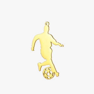 Detailed view of a golden silhouette soccer player pendant with polished metal finish