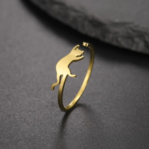 Detailed view of a golden stainless steel open ring with a playful jumping cat design