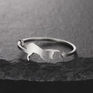 Polished stainless steel cat silhouette open ring for women on a grey stone background