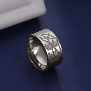 Macro detail of 10mm wide matte titanium steel ring with engraved bear patterns