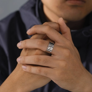 Detail of 10mm wide men's titanium ring with geometric engraved cross lines