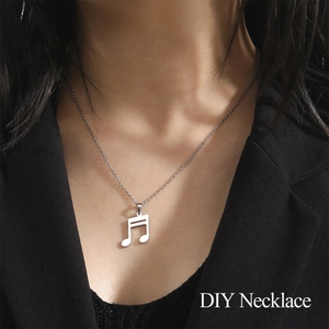 Close-up of music note pendant necklace in silver finish worn by a model