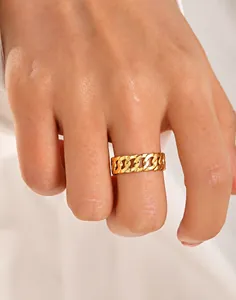 Detailed view of an 18K gold plated stainless steel Cuban chain link ring on finger