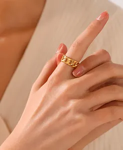 Close-up of a 18K gold plated chain ring worn on a finger with minimalist style