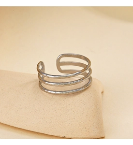 Detailed close-up of triple-layered silver ring with unique hammered texture finish