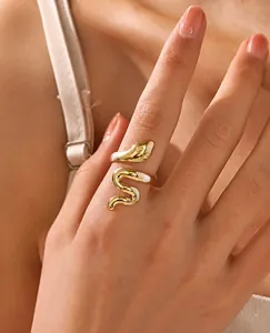 Macro detail of 18K gold plated snake ring showing polished stainless steel texture
