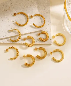 Detailed view of 18K gold-plated C-shaped earrings with twisted and beaded textures
