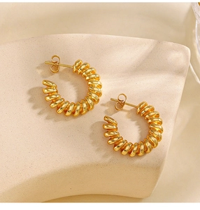 Macro shot of 18K gold plated stainless steel twisted C-shape earrings on display