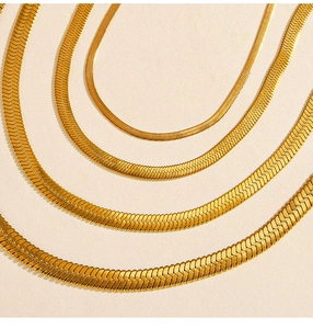 Detail view of four 18K gold plated herringbone snake chains in varying widths