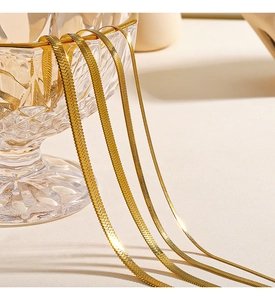 Macro view of four different widths of 18K gold plated stainless steel flat snake chains