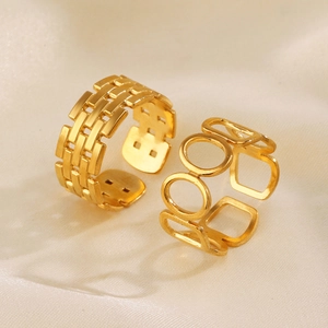 Minimalist gold geometric open rings on satin background featuring textured and oval designs