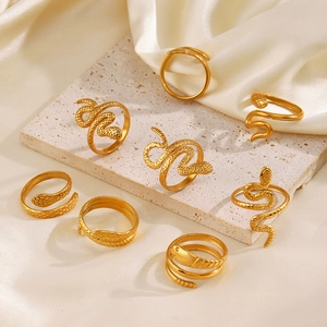 Chic gold-plated snake-shaped stainless steel rings displayed on elegant silk and stone