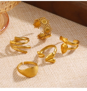 Conjunto detallado de cinco anillos de acero inoxidable dorado con diseños de sol y corazón