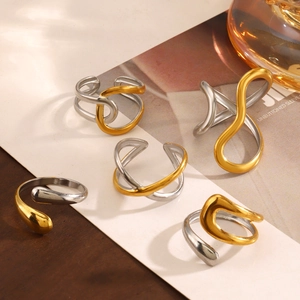Modern two-tone stainless steel rings set featuring abstract minimalist gold and silver designs