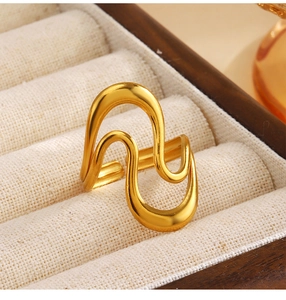 Macro view of a 18K gold plated wave ring displayed in a luxury velvet jewelry box