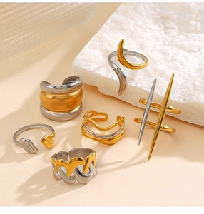 Set of six mixed gold and silver stainless steel rings with minimalist wavy patterns