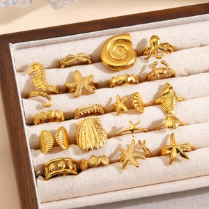 Set of 16 gold starfish and ocean themed open rings in a premium velvet display box