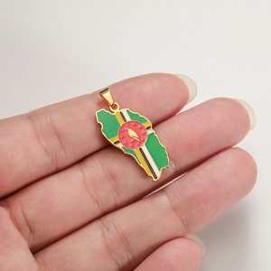 Close-up of Dominica map pendant with colorful enamel flag detail held in hand