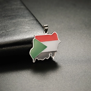 Macro detail of Sudan map charm with enamel flag colors and 18K gold plated stainless steel