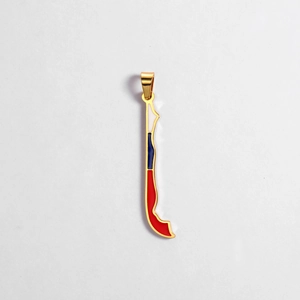 Macro detail of Chile map charm with national flag enamel and golden metal frame