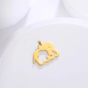 Macro detail of 18K gold plated elephant pendant showing hollow out mother and child design