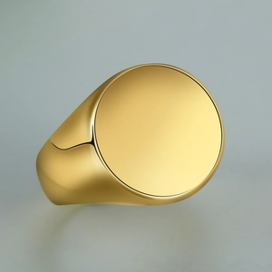 Detailed macro view of gold signet ring with polished flat top and wide metallic band