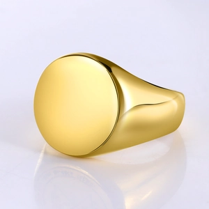 Macro detail of polished gold signet ring with a round flat surface for engraving