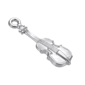 Macro detail of violin shaped metal pendant featuring intricate realistic design