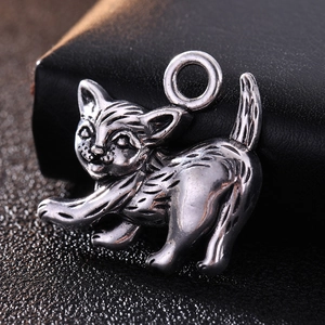 Macro shot of antique silver cat pendant with fine fur textures and integrated loop