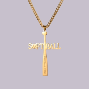 Detailed close-up of golden stainless steel softball cross pendant with motivational text