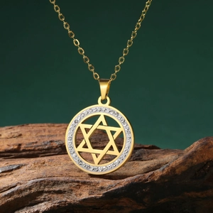 Gold stainless steel Star of David necklace with crystal halo on dark wood base