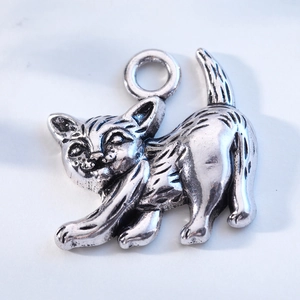 Macro view of vintage silver alloy cat pendant with detailed fur texture and ring