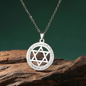 Detailed macro view of silver star of David pendant with shimmering zircon pavé stones