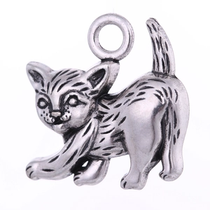 Macro shot of antique silver cat pendant with detailed fur texture and vintage finish