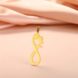 Macro detail of gold minimalist hugging couple pendant with polished mirror finish texture