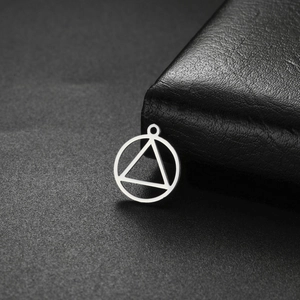 Pendentif géométrique circulaire argenté avec triangle sur fond en cuir noir élégant