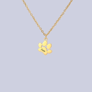 Macro shot of 18K gold plated custom cat paw pendant with personalized Japp engraving