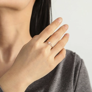 Minimalist stainless steel moon and sun open rings worn on model's hand in silver finish