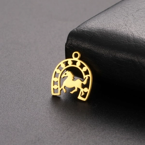 Macro detail of 18K gold plated stainless steel horseshoe pendant with horse silhouette
