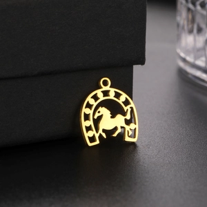 Detail of 18K gold plated stainless steel horseshoe pendant with a hollow horse design