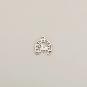 Detailed close-up of a silver polished horseshoe pendant with a galloping horse silhouette