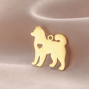Detail of 18k gold plated stainless steel Samoyed dog charm with heart cutout and ring