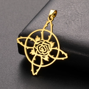 Detailed close-up of a gold rose pendant with gothic star frame on dark leather