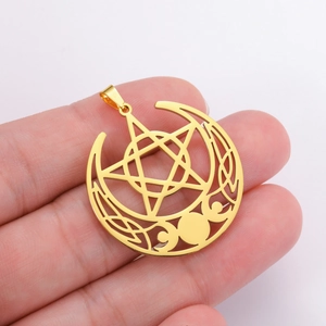 Macro detail of gold stainless steel triple moon pentagram pendant in hand