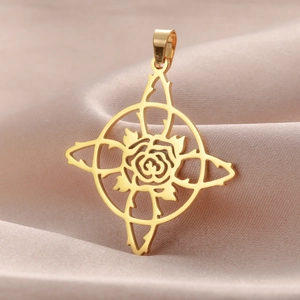 Detailed view of a gold rose pendant with thorns on a premium champagne silk background