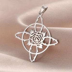 Vintage stainless steel rose pendant in witch knot frame on beige silk background