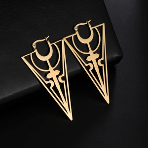 Golden hollow triangle earrings with cross design on elegant black leather surface