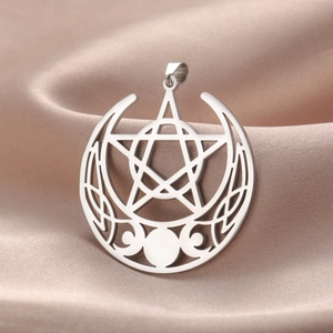 Detailed close-up of a silver stainless steel triple moon pentagram pendant on satin fabric