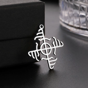Macro shot of silver stainless steel Viking rune pendant on a matte jewelry box