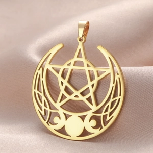 Detailed close-up of a gold stainless steel triple moon pentagram pendant on silk fabric